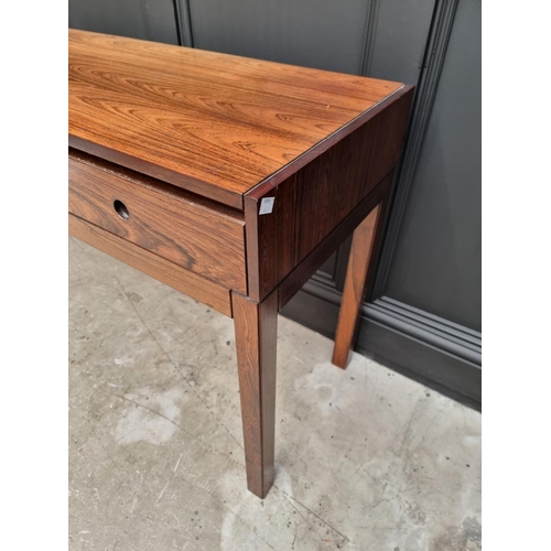 1089 - A mid-century rosewood side table, 152.5cm wide.