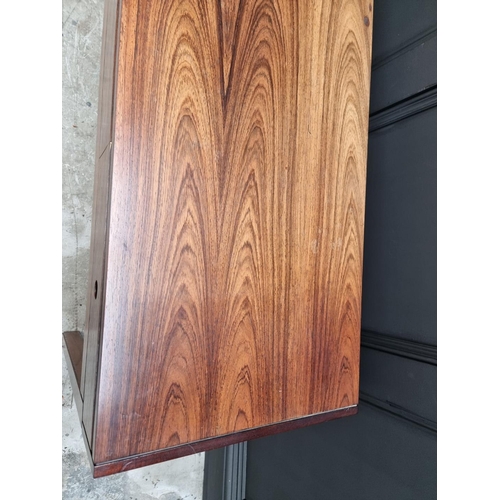 1089 - A mid-century rosewood side table, 152.5cm wide.