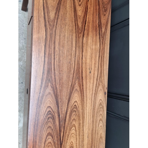 1089 - A mid-century rosewood side table, 152.5cm wide.