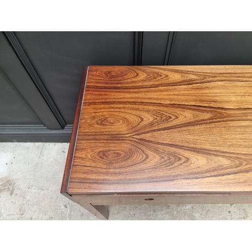 1089 - A mid-century rosewood side table, 152.5cm wide.