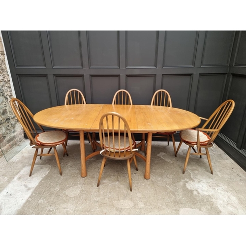 1090 - An Ercol drawleaf dining table and set of six chairs, to include a pair of elbow chairs, the table 2... 