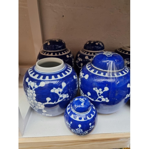 1129 - Fourteen Chinese blue and white ginger jars and eight covers, largest 14.5cm high.