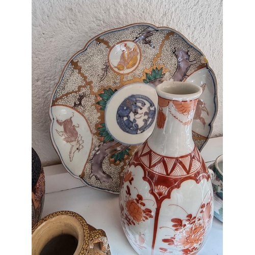 1139 - A mixed group of Chinese and Japanese pottery and porcelain, to include two yixing teapots and cover... 