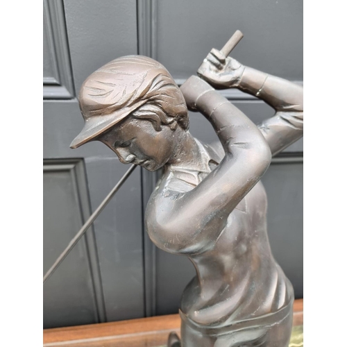 1154 - A large bronze figure of a lady golfer, 60cm high. 