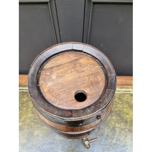 1162 - A coopered oak spirit barrel, 35.5cm high, with brass tap.