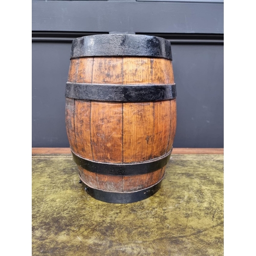 1162 - A coopered oak spirit barrel, 35.5cm high, with brass tap.