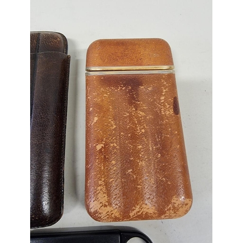 220 - Three leather cigar cases; together with six cigar cutters. (9)