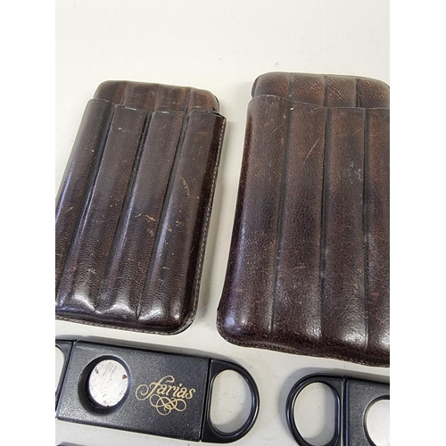 220 - Three leather cigar cases; together with six cigar cutters. (9)