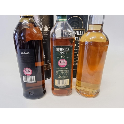 47 - Three bottles of whisky, comprising: Glenfiddich 18 year old, in card tube; a Bushmills 10 year old,... 