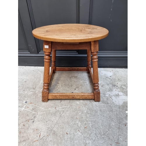 1040 - An oak circular occasional table, 53.5cm wide.