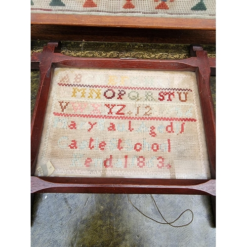 1121 - Two Victorian woolwork samplers, one by 'Emma Todd, Waterside, Aged 13, 1883', 31 x 31cm; the second... 