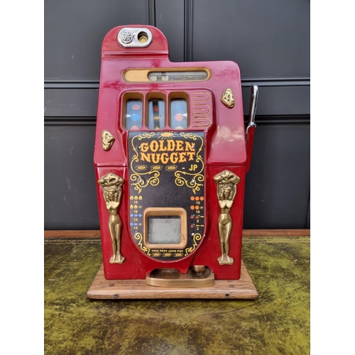 A vintage Bell's 'Golden Nugget' one arm bandit arcade machine