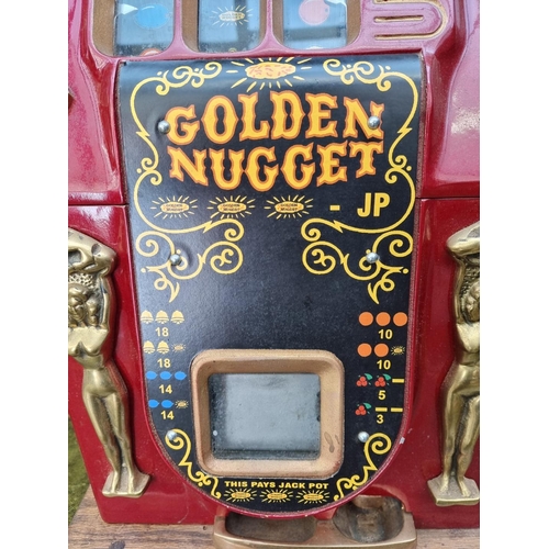 A vintage Bell's 'Golden Nugget' one arm bandit arcade machine