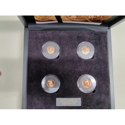 261 - Coins: a 'Queen Elizabeth II The Royal Jubilees Gold Coin Set', comprising: two sovereigns; and two ... 