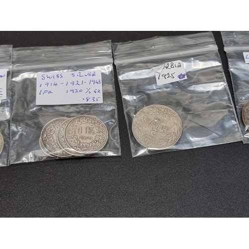 454 - Coins: seventeen German, Swiss and other coins, to include five silver examples.