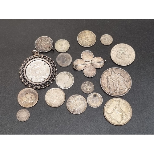 460 - Coins: a small quantity of foreign white metal coinage; to include a French 1965 10 francs.... 