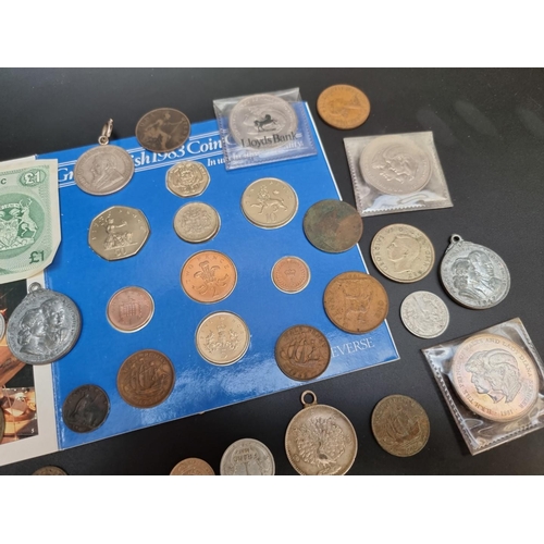 479 - Coins: a small quantity of UK and world coins; together with a Royal Bank of Scotland one pound note... 