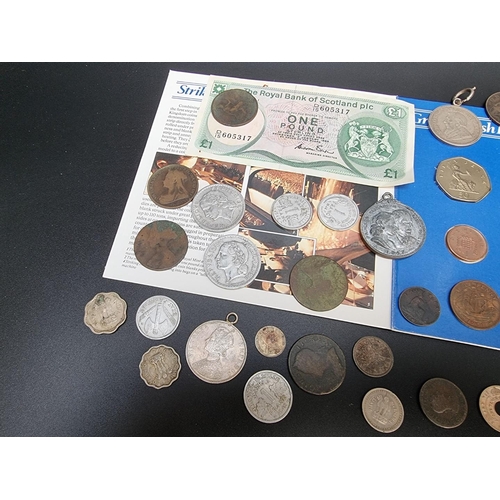 479 - Coins: a small quantity of UK and world coins; together with a Royal Bank of Scotland one pound note... 