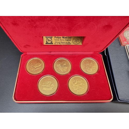 499 - Coins: a quantity of boxed commemorative medals, coins and similar.