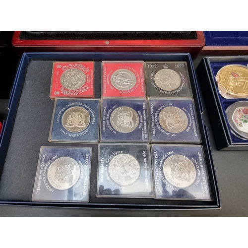 499 - Coins: a quantity of boxed commemorative medals, coins and similar.