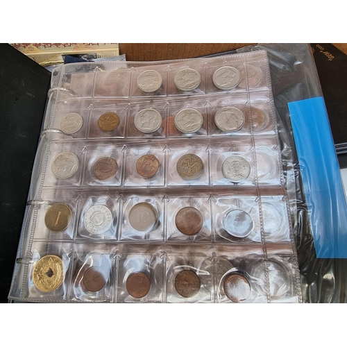 499 - Coins: a quantity of boxed commemorative medals, coins and similar.