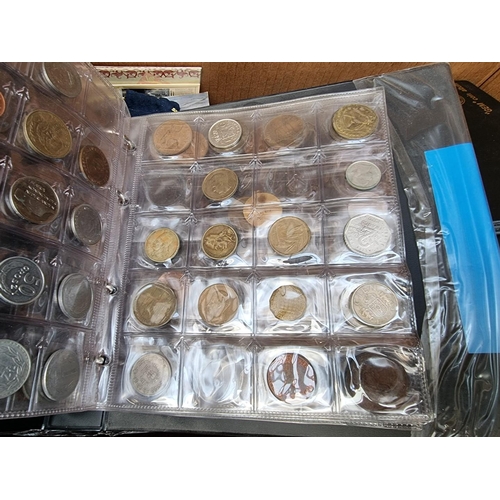 499 - Coins: a quantity of boxed commemorative medals, coins and similar.