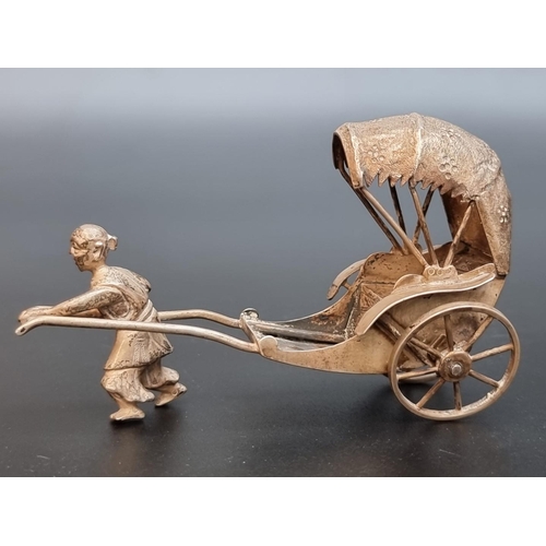 509 - A Chinese white metal rickshaw figure, by Hung Chong, 9cm.