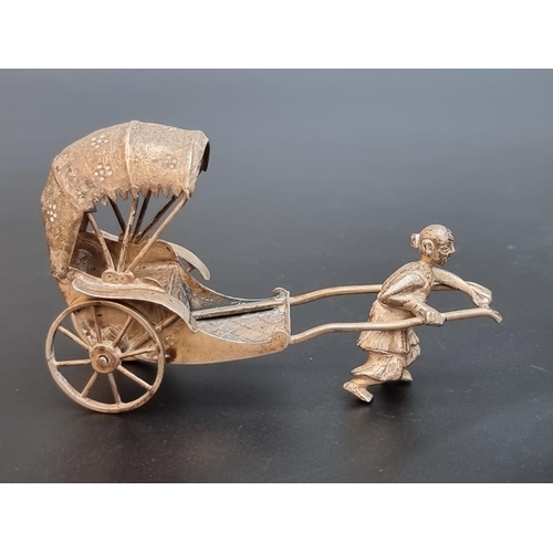 509 - A Chinese white metal rickshaw figure, by Hung Chong, 9cm.