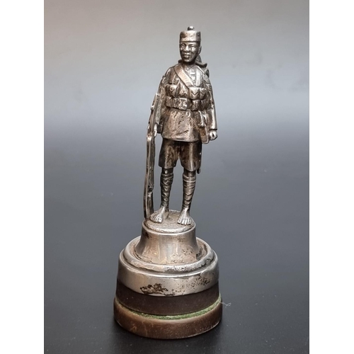 535 - A silver model of a Gurkha sergeant, London 1927, weighted, total height 12cm.