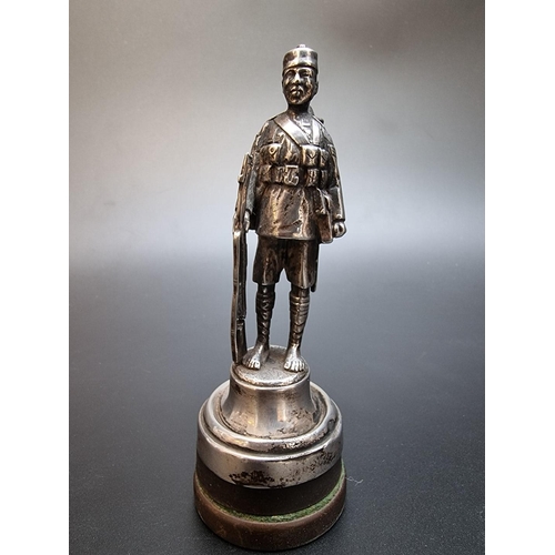 535 - A silver model of a Gurkha sergeant, London 1927, weighted, total height 12cm.