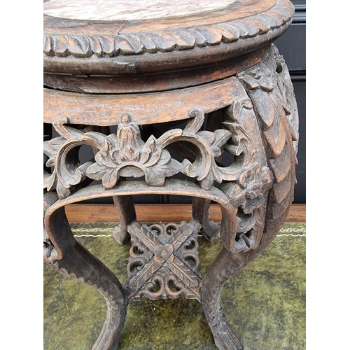 1041 - A Chinese carved hardwood and marble inset jardiniere stand, 61.5cm high.