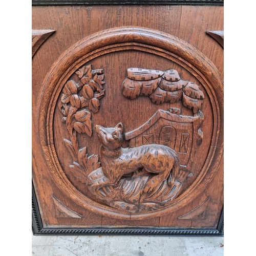 1008 - A pair of carved oak relief panels, of a dog and fox, in ebonized frames, the whole 57 x 53cm.&... 