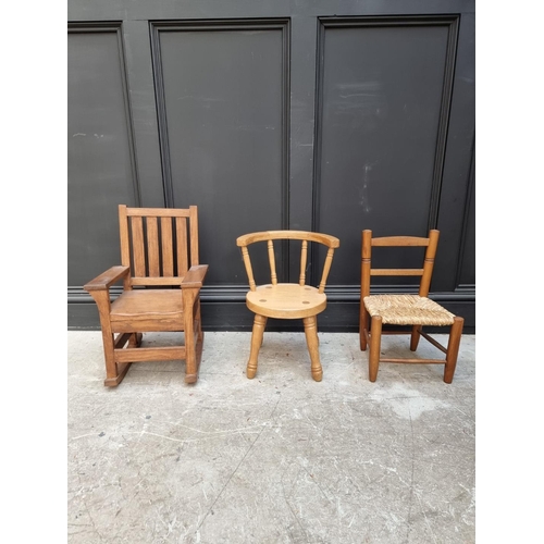 1010 - Three child's chairs, comprising two oak examples; and another beech and rush seated example.... 