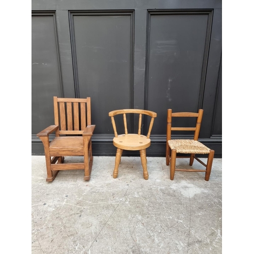 1010 - Three child's chairs, comprising two oak examples; and another beech and rush seated example.... 