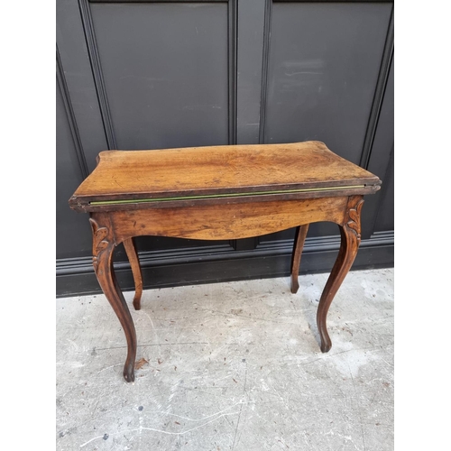 1018 - A Victorian walnut card table, of serpentine outline, 83cm wide.