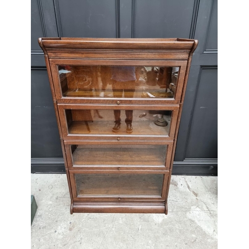1027 - An early 20th century oak four tier sectional bookcase, in the Globe Wernicke style, 142cm high x 86... 