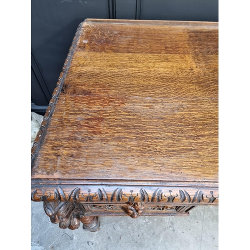 1043 - A late Victorian carved oak 'Green Man' desk, 133cm wide. 