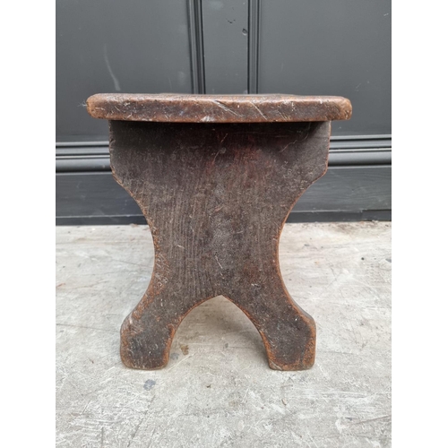 1046 - An antique elm milking stool, 31cm high x 38cm wide. 