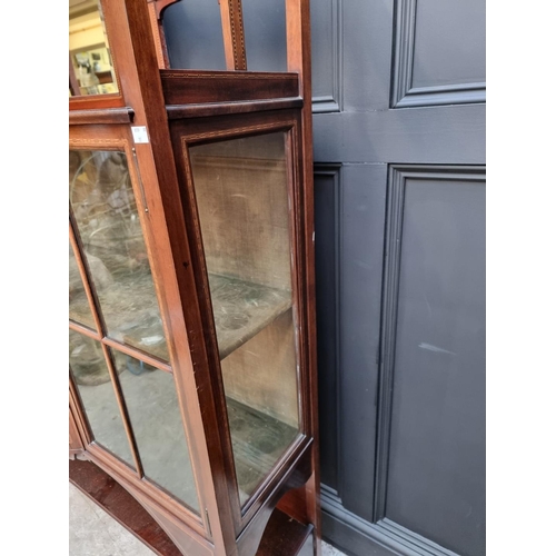 1052 - A good circa 1900 mahogany and inlaid display cabinet, with bowfront centre and platform undert... 
