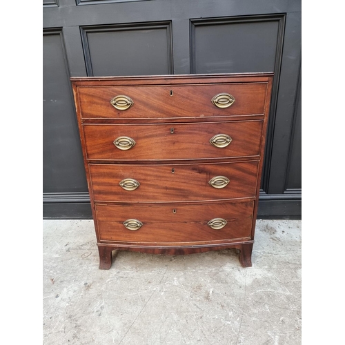 1054 - A George III mahogany and crossbanded bowfront four drawer chest, 78cm wide.