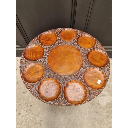 1061 - An Indian carved hardwood low circular table, with dished top, 56cm diameter.