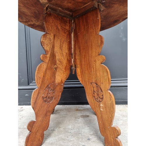 1061 - An Indian carved hardwood low circular table, with dished top, 56cm diameter.