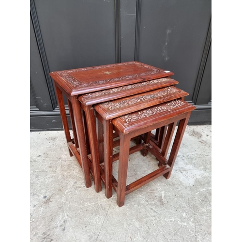 1063 - A nest of four Eastern carved hardwood and brass inlaid quartetto tables, largest 53cm wide. &n... 