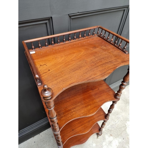 1065 - A Victorian mahogany serpentine fronted four tier whatnot, 47.5cm wide. 