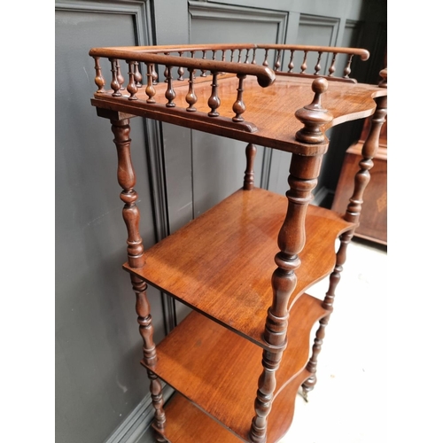 1065 - A Victorian mahogany serpentine fronted four tier whatnot, 47.5cm wide. 