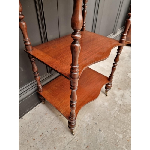 1065 - A Victorian mahogany serpentine fronted four tier whatnot, 47.5cm wide. 