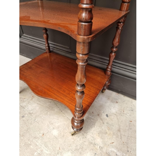 1065 - A Victorian mahogany serpentine fronted four tier whatnot, 47.5cm wide. 