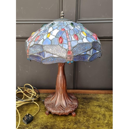 1066 - A bronzed, stained and leaded glass table lamp, 57cm high.