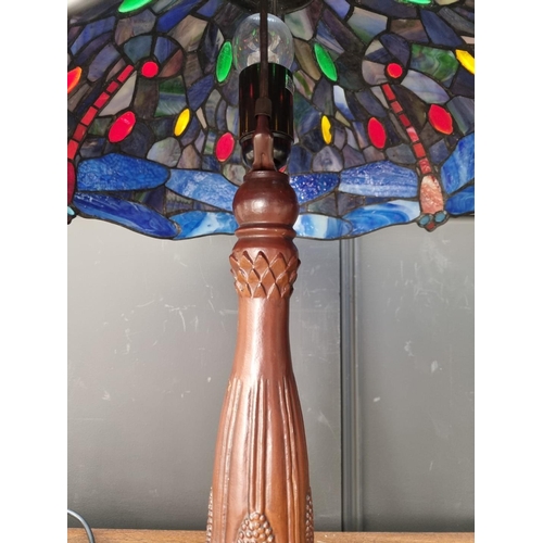 1066 - A bronzed, stained and leaded glass table lamp, 57cm high.