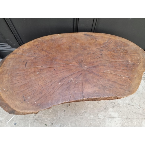 1069 - An oak tree truck low occasional table, 86cm wide.